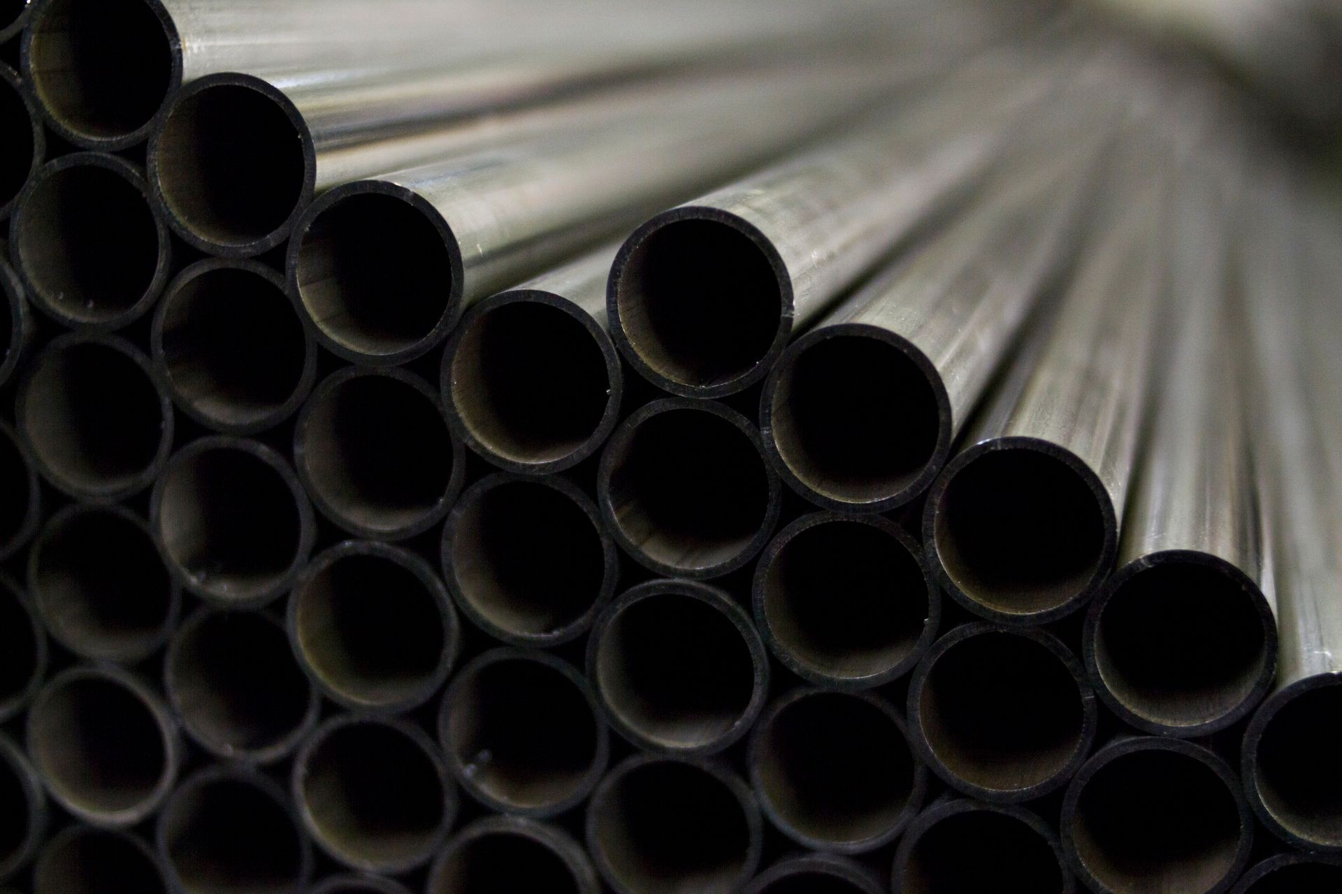 Lot of industrial metal steel pipes tubes for production for heating or engineering industry processing cutting welding and other work